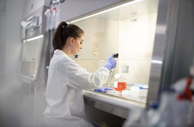woman with pipette in lab